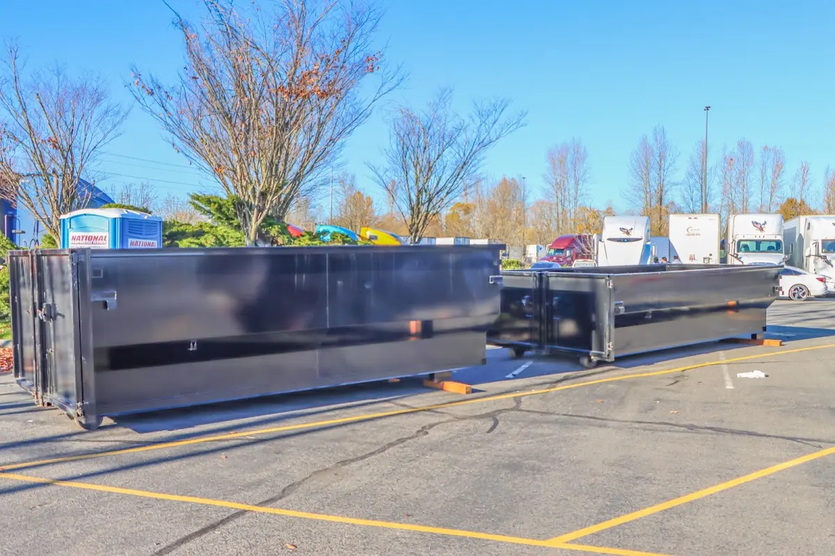 Professional dumpster rental service with roll-off container on residential driveway in Palm Springs North